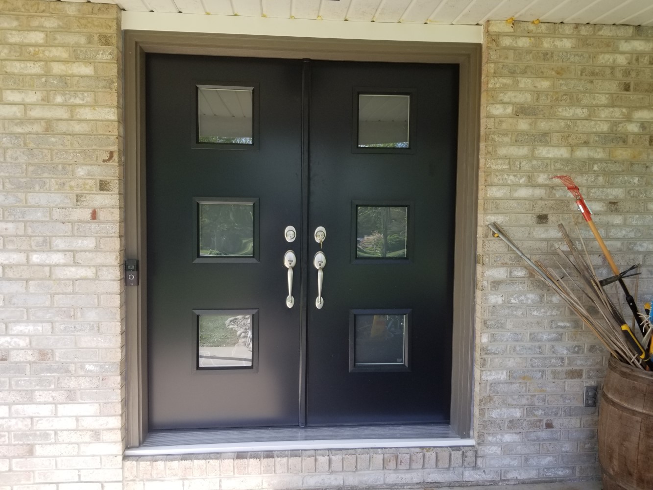 black double doors in front entrance with modern triple window layout