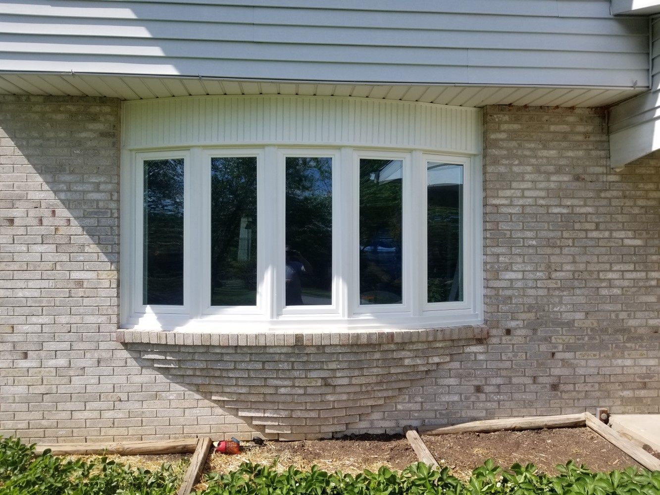 five section front window with decorative brickwork and panelling around it