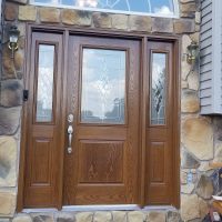 beautiful wood front door with diamond glass accents